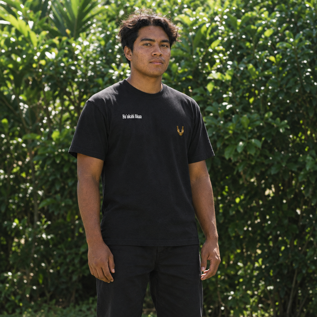 Black tee model in a leafy Hawaiian setting